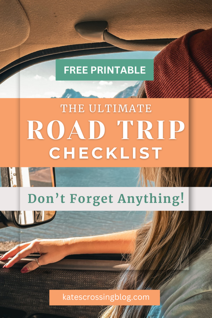 Pinterest pin cover reads, "The Ultimate Road Trip Checklist, Don't Forget Anything," with a picture of Kate sitting in the front seat of a car in the background. She is looking out at a lake with mountains in the background.