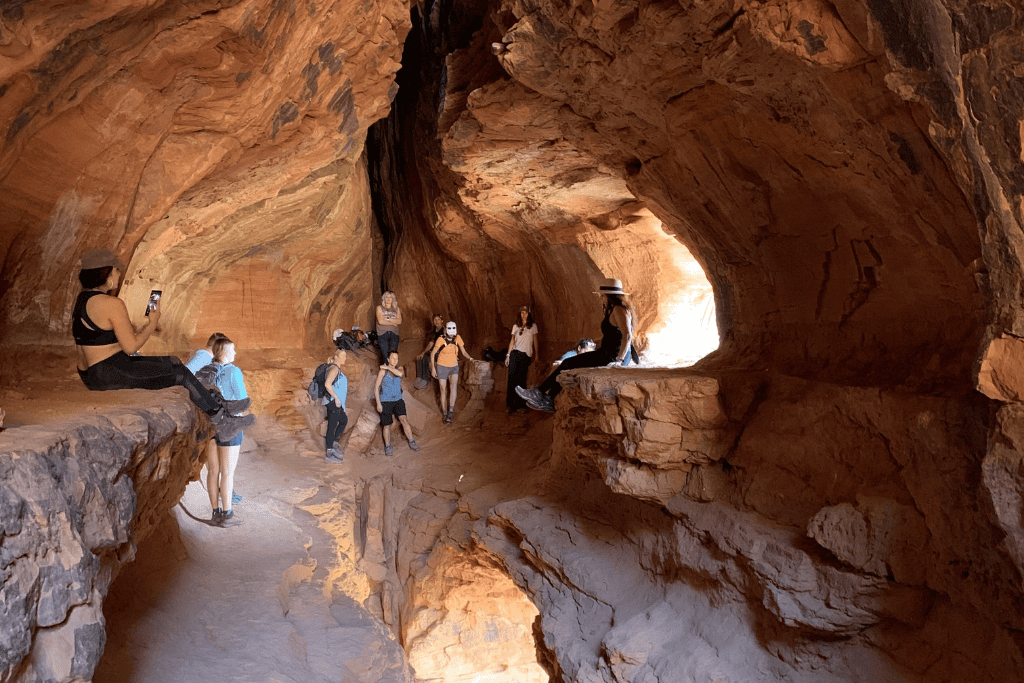 View from inside the hidden cave on Soldier Pass Trail with hikers inside the cave.
