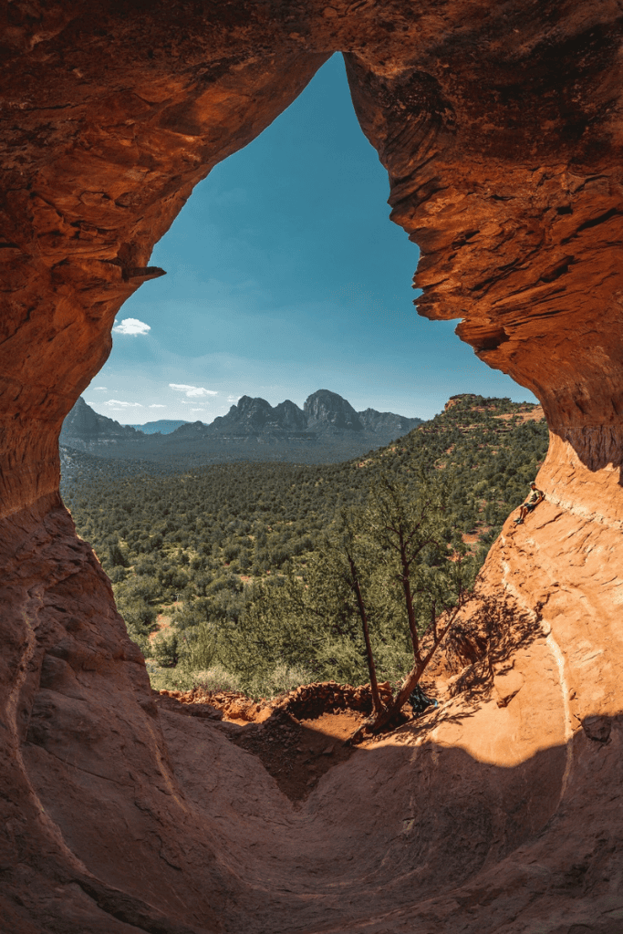 Views from inside the birthing cave looking out at the desert with blue sky.