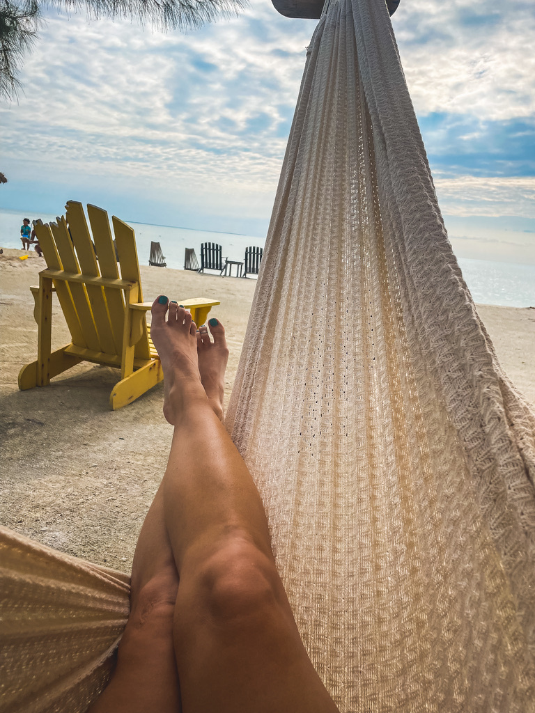 Relaxing in a hammock with a view of the beach and ocean in Belize.