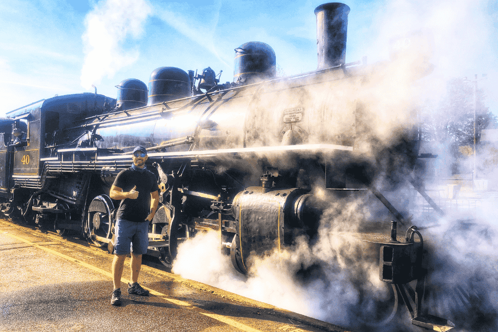 Kate’s husband stands in front of the steam-spewing black locomotive No. 40 in Essex, Connecticut, giving a thumbs-up with a big smile.