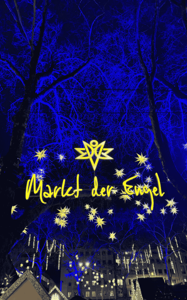 The glowing yellow sign “Markt der Engel” shines among star-shaped lights strung through tree branches against a deep blue night sky at the Cologne Christmas Market.