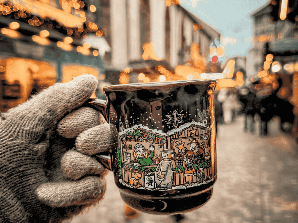 Visitors browse a festive food stall and gather under red umbrellas at the Basel Christmas market.






You said:


ChatGPT said:
The Basel Christmas market glows at night with twinkling lights, decorated stalls, and festive crowds.






You said:


ChatGPT said:
People enjoy food and drinks at festive street stalls beside a decorated double-decker bus in Basel at night.






You said:


ChatGPT said:
A gloved hand holds a festive illustrated mug of hot drink at the Basel Christmas market.