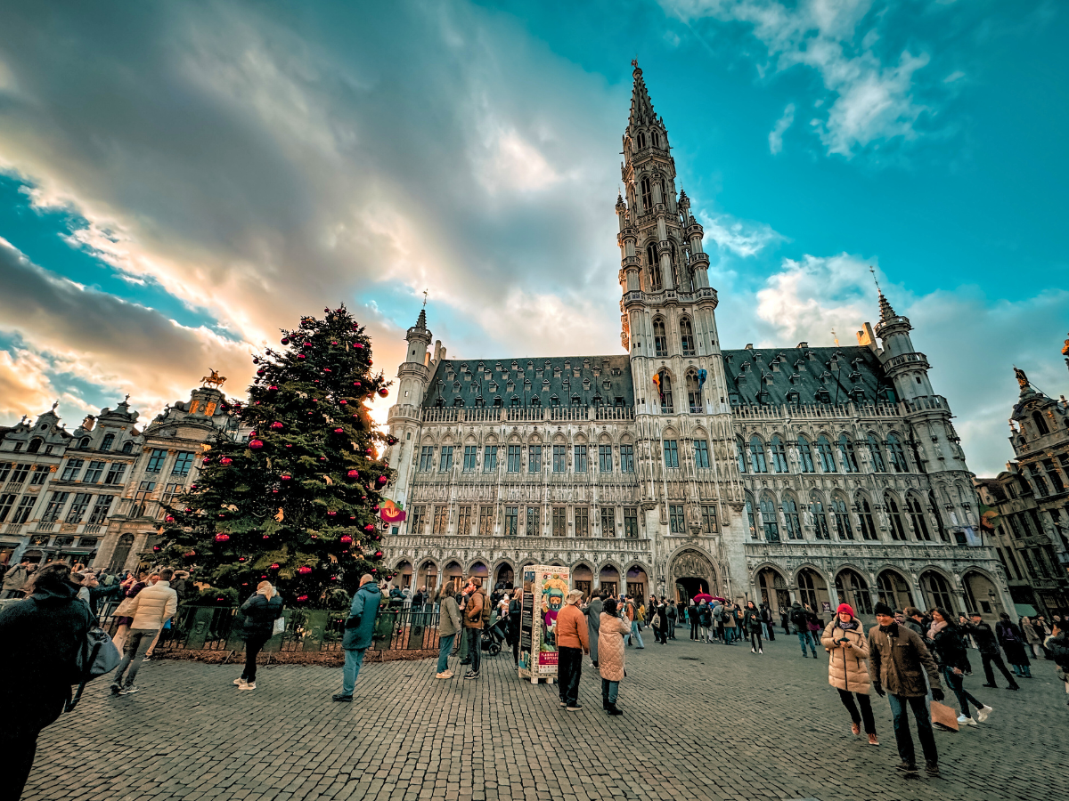A giant Christmas tree stands in front of the ornate Town Hall at Brussels’ Grand Place.