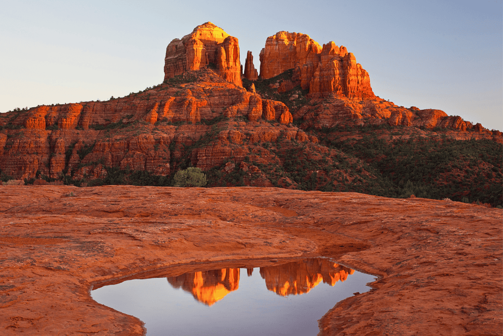 Reflection of cathedral rock in a water puddle.