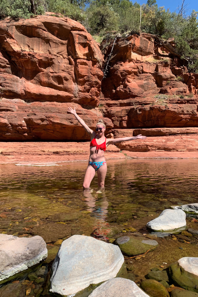 Kate wading in a deep pool at slide rock state park.