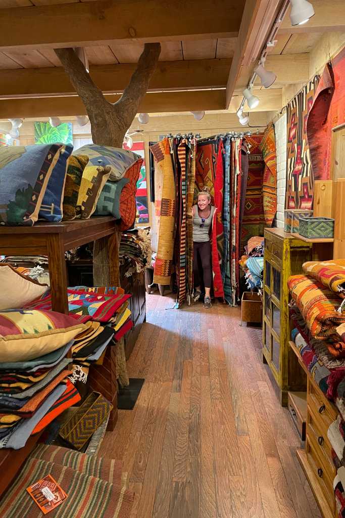 Kate shopping for rugs in a shop in Sedona.