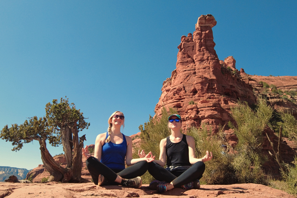 Kate and a friend sitting peacefully in the middle of a vortex in Sedona.