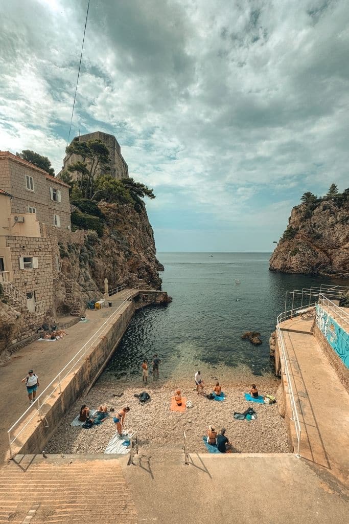 People relaxing on Beach Šulić, tucked in a small cove in Dubrovnik. 