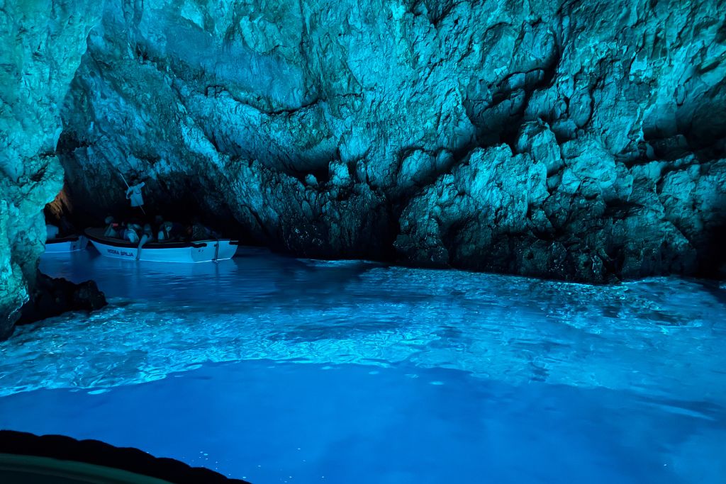 The glowing blue waters inside the Blue Grotto in Croatia reflect on the walls of the cave turning them bright blue too.
