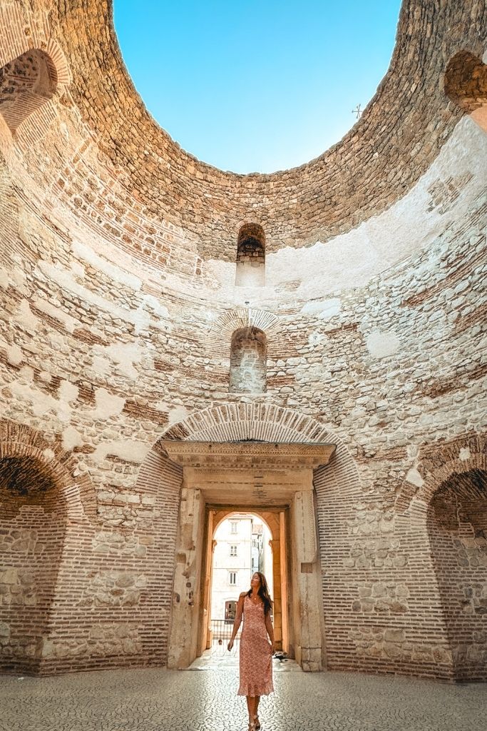 Kate walking beneath the ruins all by herself in Split, Croatia.