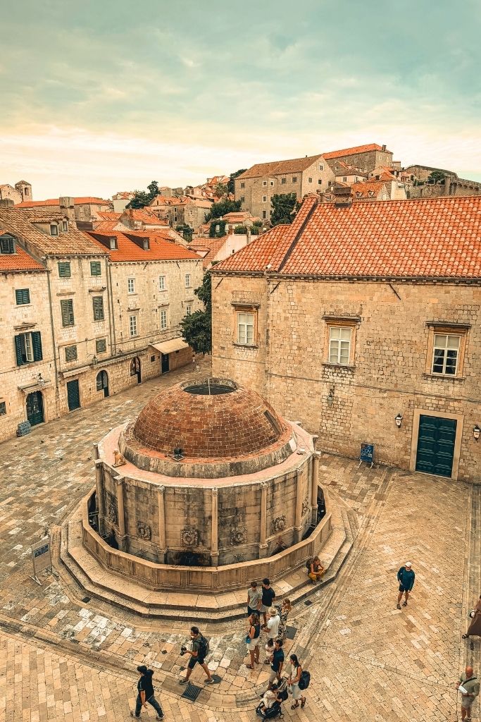 Square inside Dubrovnik walls with a large fountain in the middle. 
