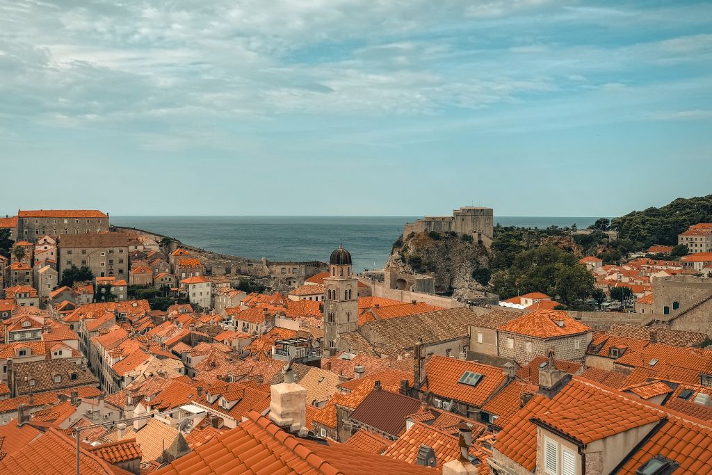 View of Dubrovnik's red roof tops with the Adriatic sea in the background.
