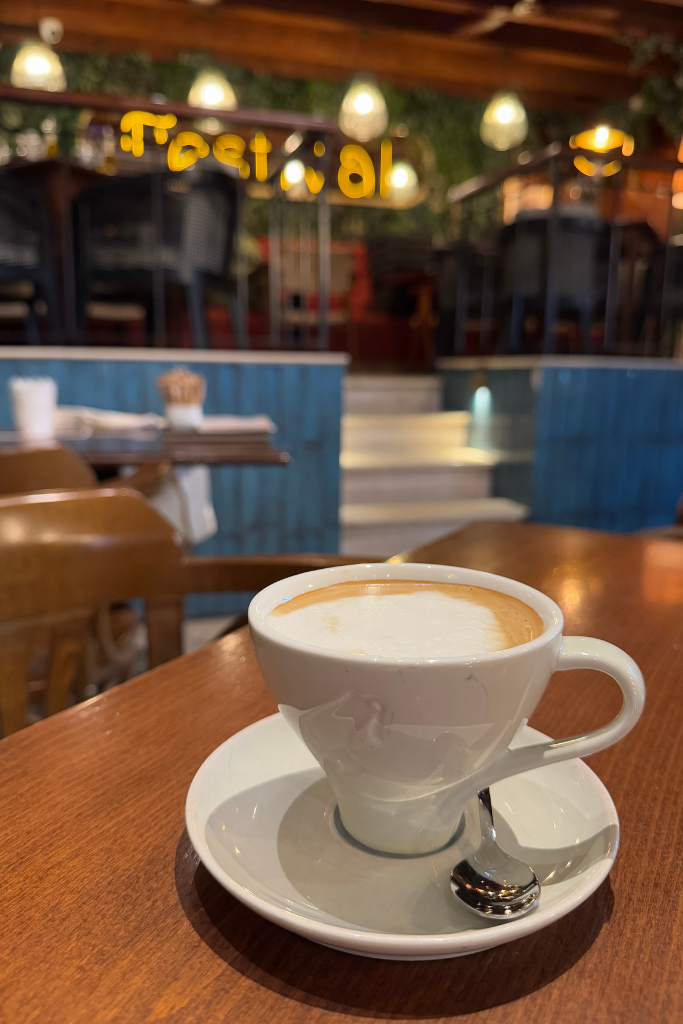 Cappuccino sitting on a table in a jazzy cafe.