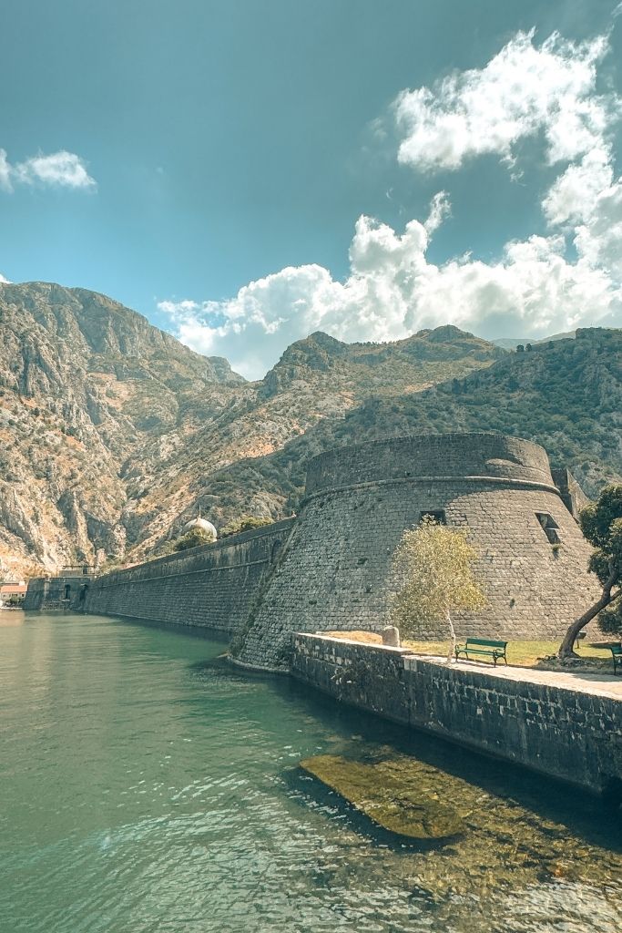 A stone fortress of Kotor below a mountain backdrop.
