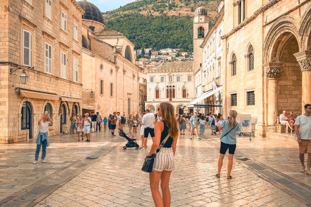 Kate is walking down a main street in Dubrovnik's Old Town.