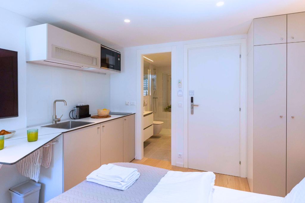 A hotel room with a kitchenette