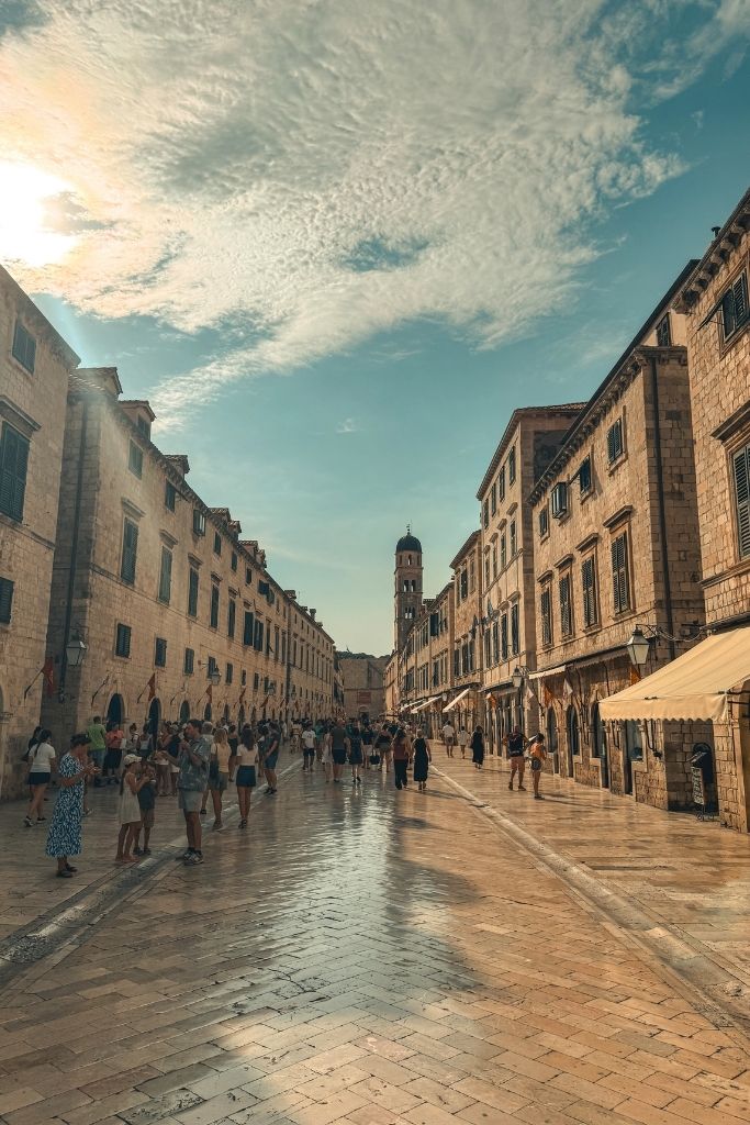 Polished Stradun Street in Dubrovnik Old Town in the evening with golden light.