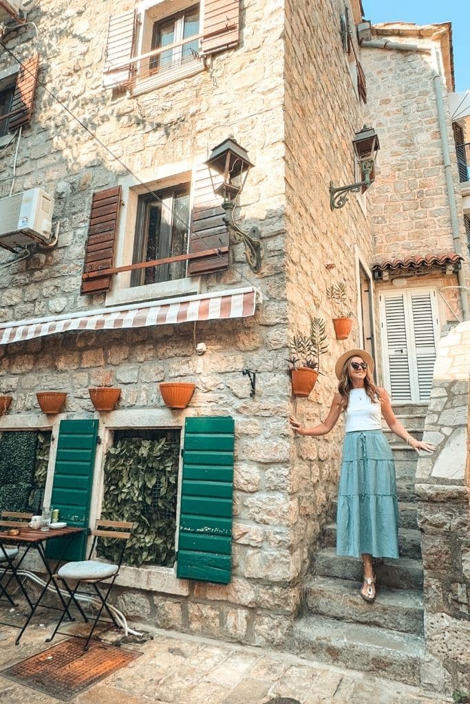 Kate explores the charming stone stairways and historic alleyways of Budva’s Old Town, surrounded by beautiful Mediterranean architecture and coastal charm.