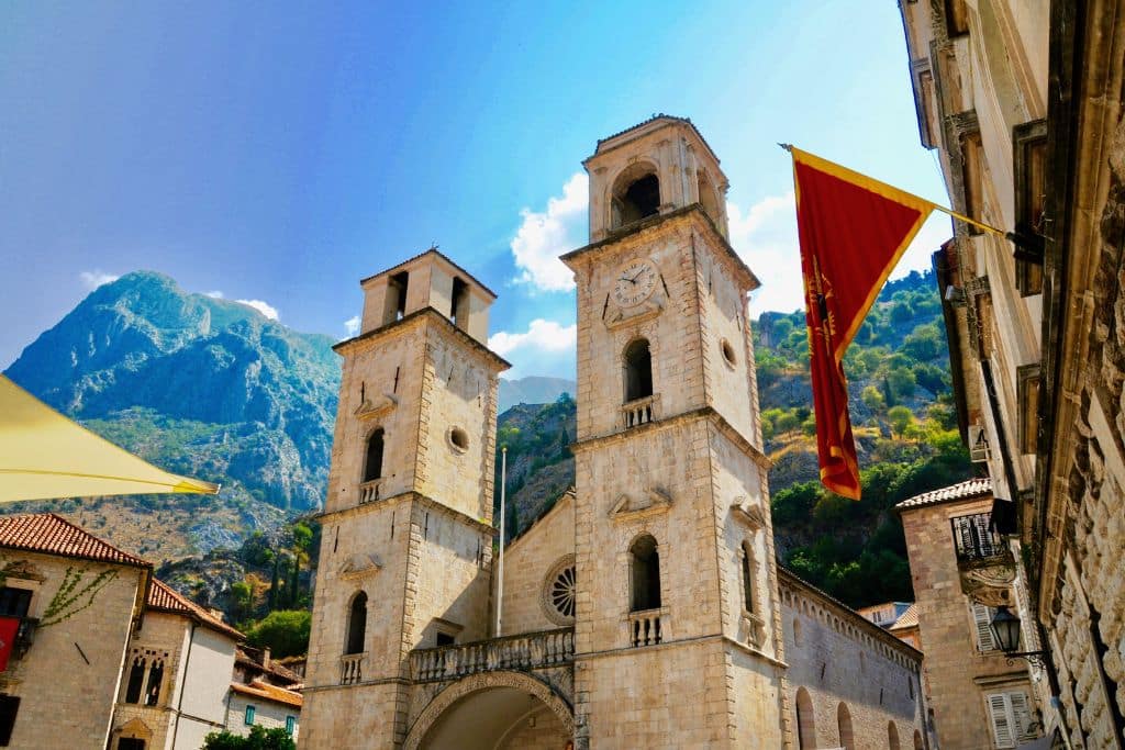 The stunning twin bell towers of Kotor Cathedral rise against the dramatic mountain backdrop of Montenegro’s breathtaking Old Town.