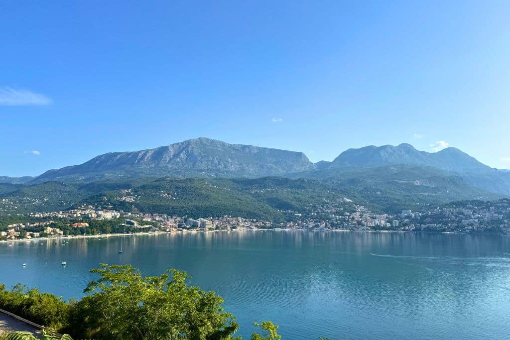 A breathtaking view of Montenegro’s coastline where calm blue water meets dramatic mountain scenery along the Bay of Kotor.