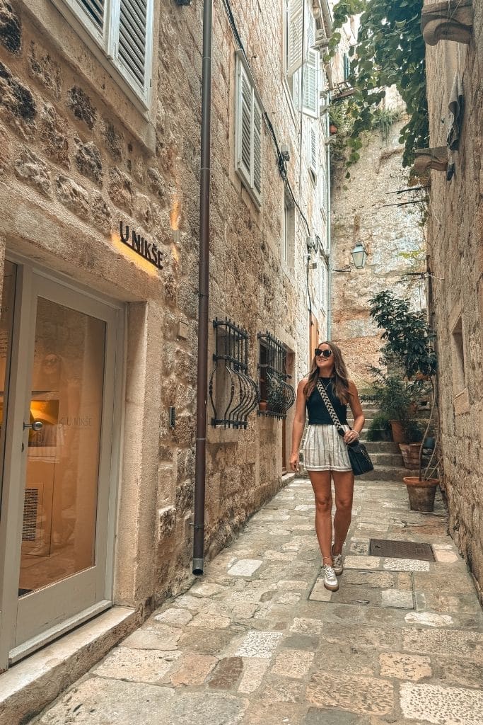 Kate walking to her hotel entrance at Apartments u Nikse in Dubrovnik.