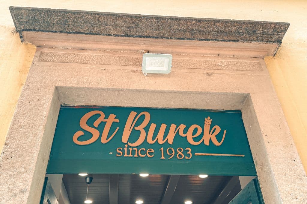 Sign over a store entry that says ST Burek, since 1983.
