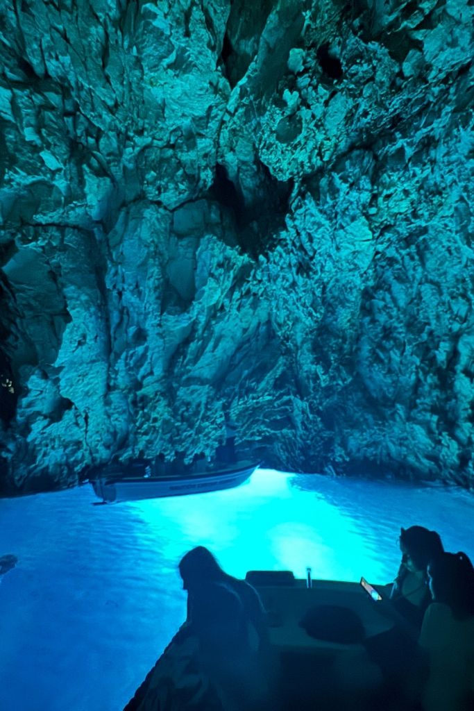 Glowing blue waters reflecting on the cafe ceiling and walls in a blue grotto. 