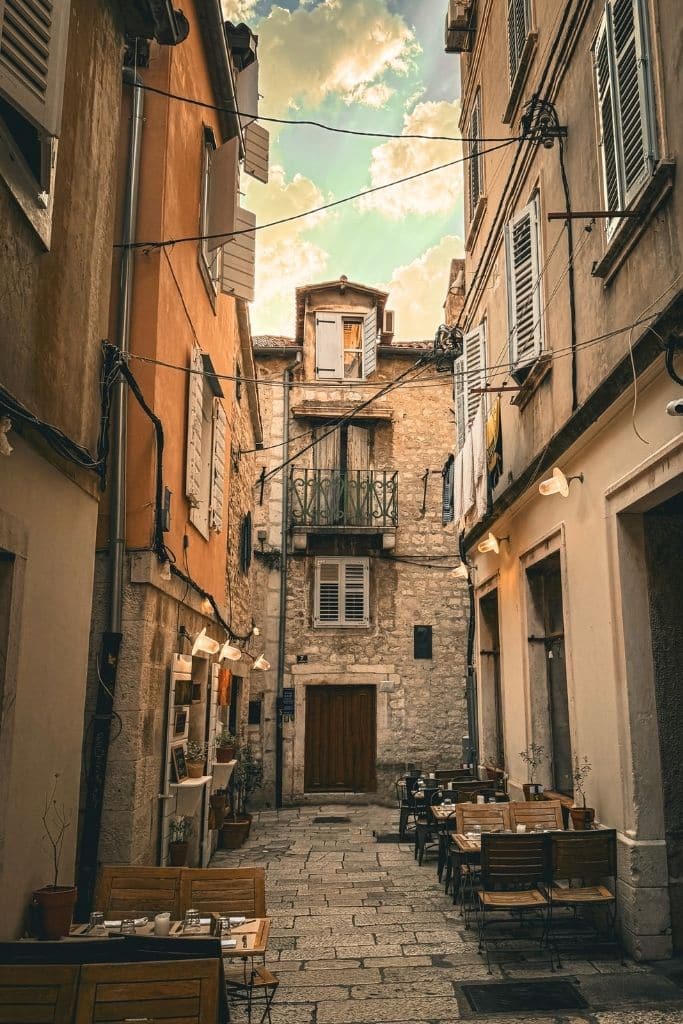 The front of Mint Luxury Rooms Hotel at the end of a narrow cobblestone street in Split.