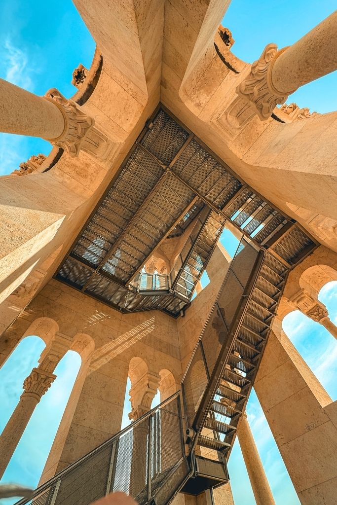 Upward view of a metal stair case spiraling up a bell tower in Split.