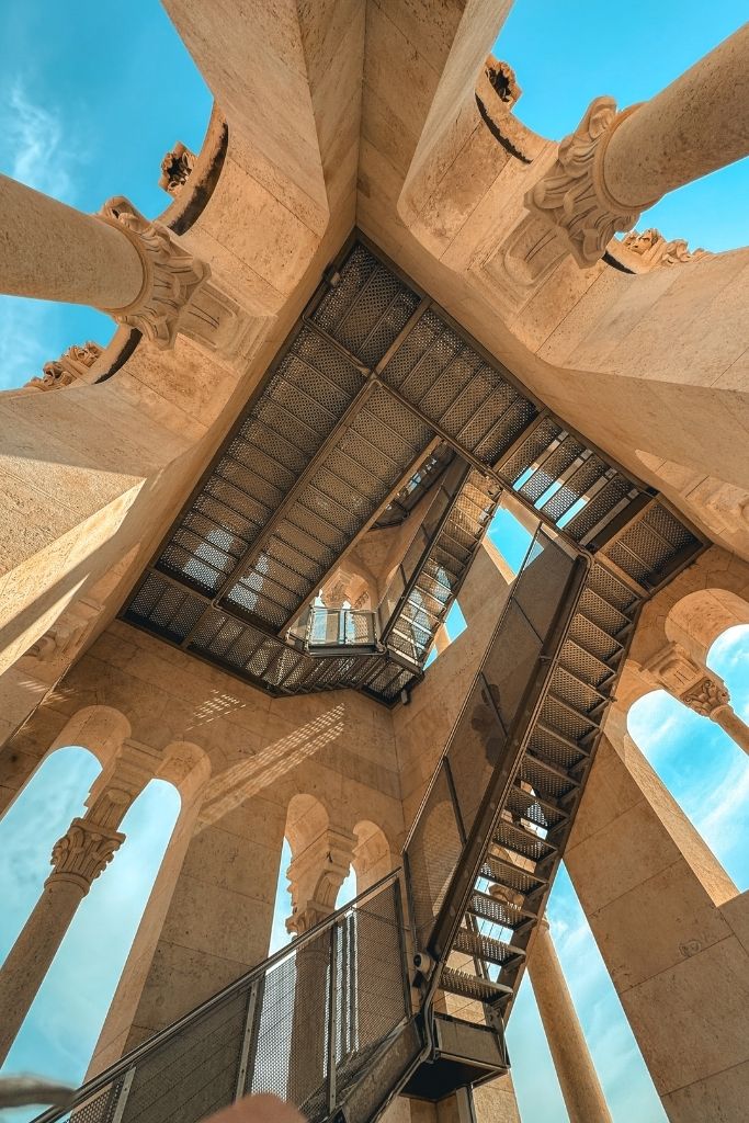 The metal staircases inside the Bell Tower of Saint Domnius wind upward between elegant stone columns, offering visitors a unique perspective as they climb toward the panoramic views at the top.