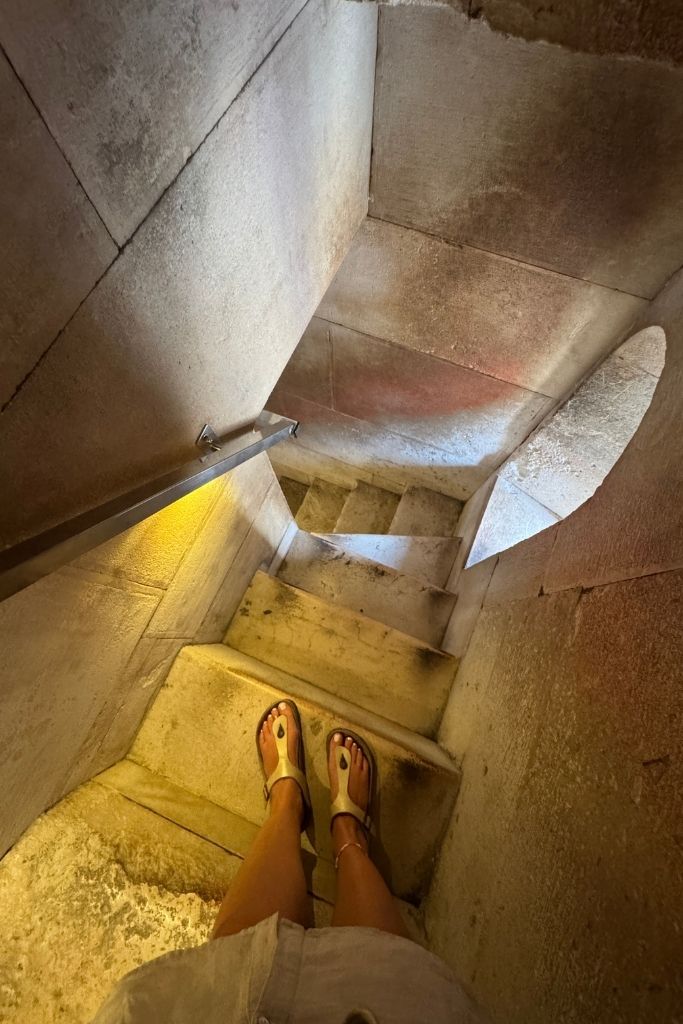 A narrow stone staircase winds through the interior of the Bell Tower of Saint Domnius, giving visitors a glimpse of the steep climb required to reach the panoramic views at the top.