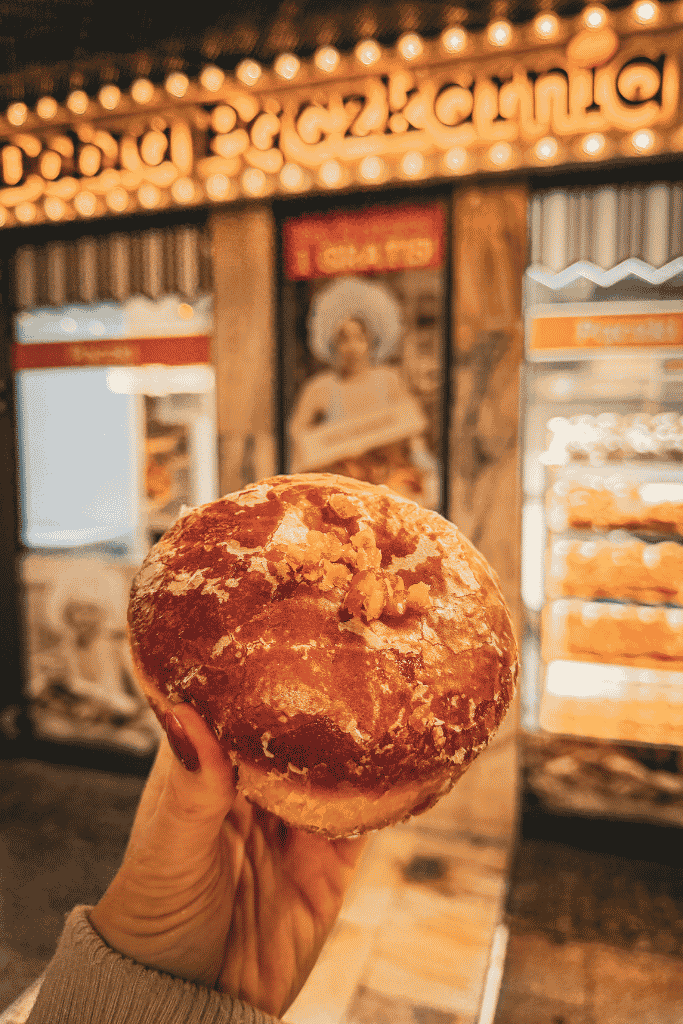 A traditional Polish pączek, a fluffy filled donut, from a bakery in Krakow, Poland.