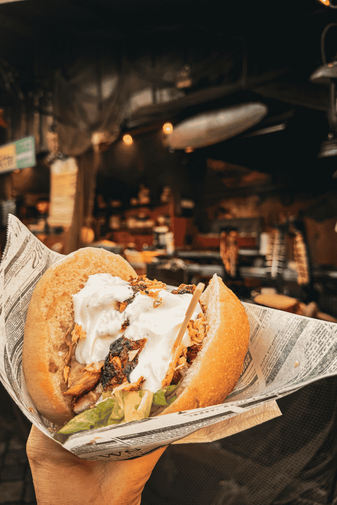 A hearty sandwich piled with savory salmon and creamy sauce.