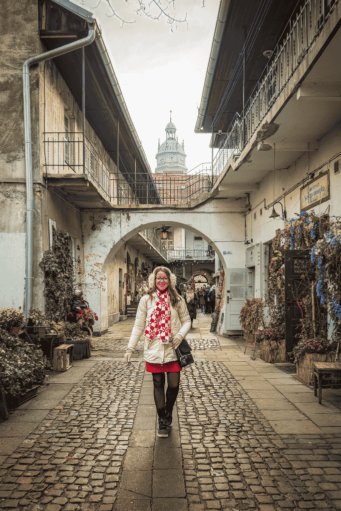 Walking through a historic courtyard in Krakow’s Kazimierz Jewish Quarter, one of the filming locations featured in Schindler’s List.
