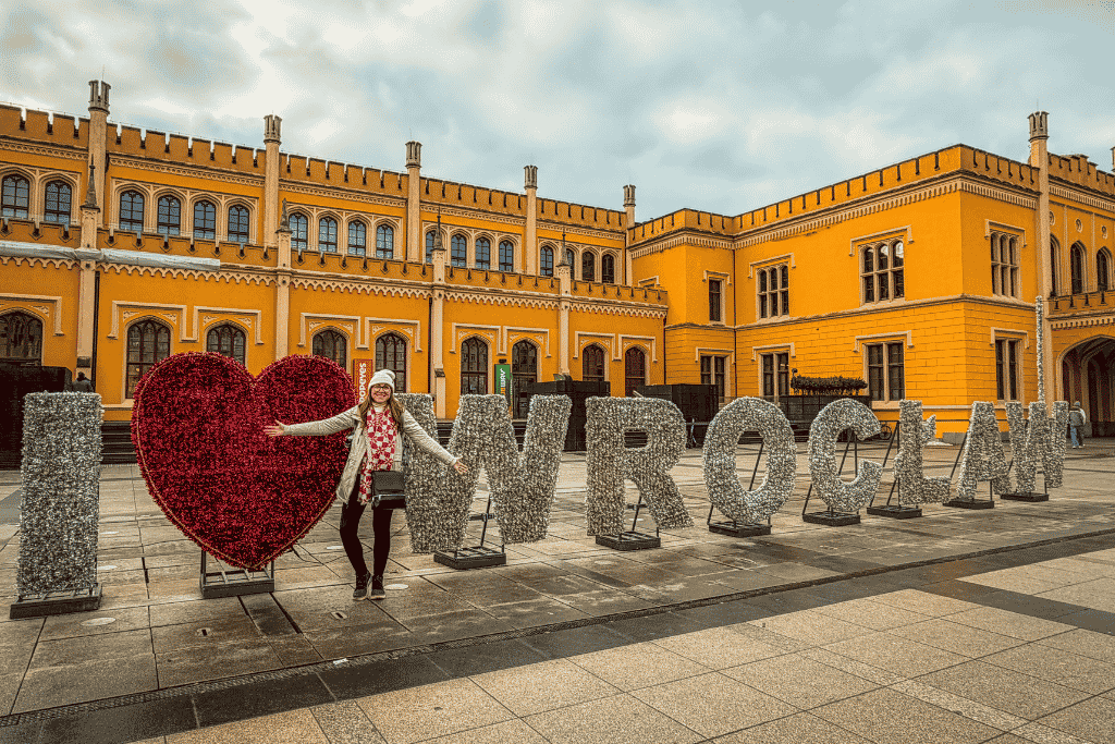 Kate posing beside the I Love Wroclaw sign outside Wroclaw Main Railway Station in Poland.