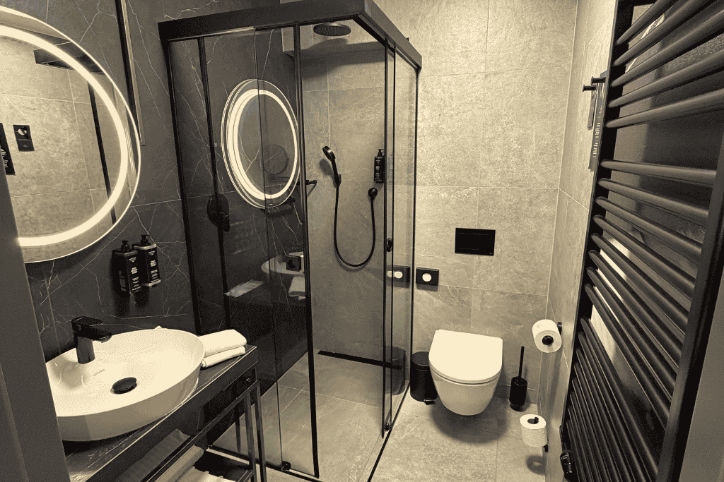 A modern bathroom with a glass-enclosed shower at Garamond, a Tribute Portfolio Hotel in Krakow.