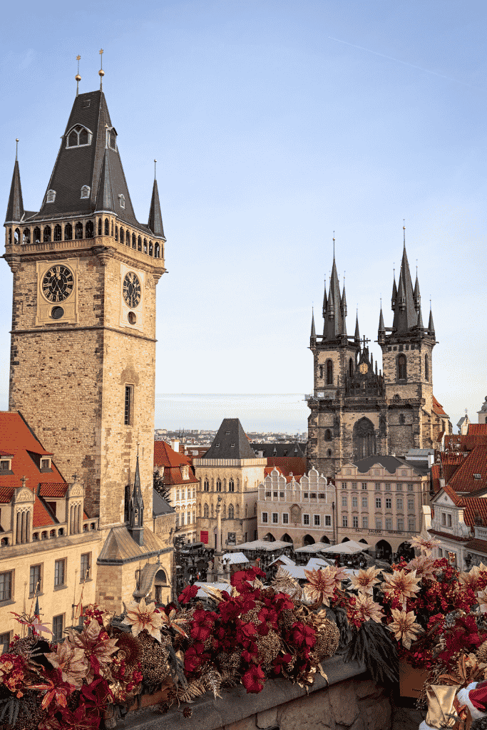 View over Prague’s Old Town Square featuring the Old Town Hall tower, Church of Our Lady before Týn, and festive Christmas decorations.