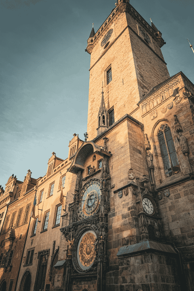 Prague Astronomical Clock on the Old Town Hall tower in Old Town Square, illuminated by warm winter sunlight.