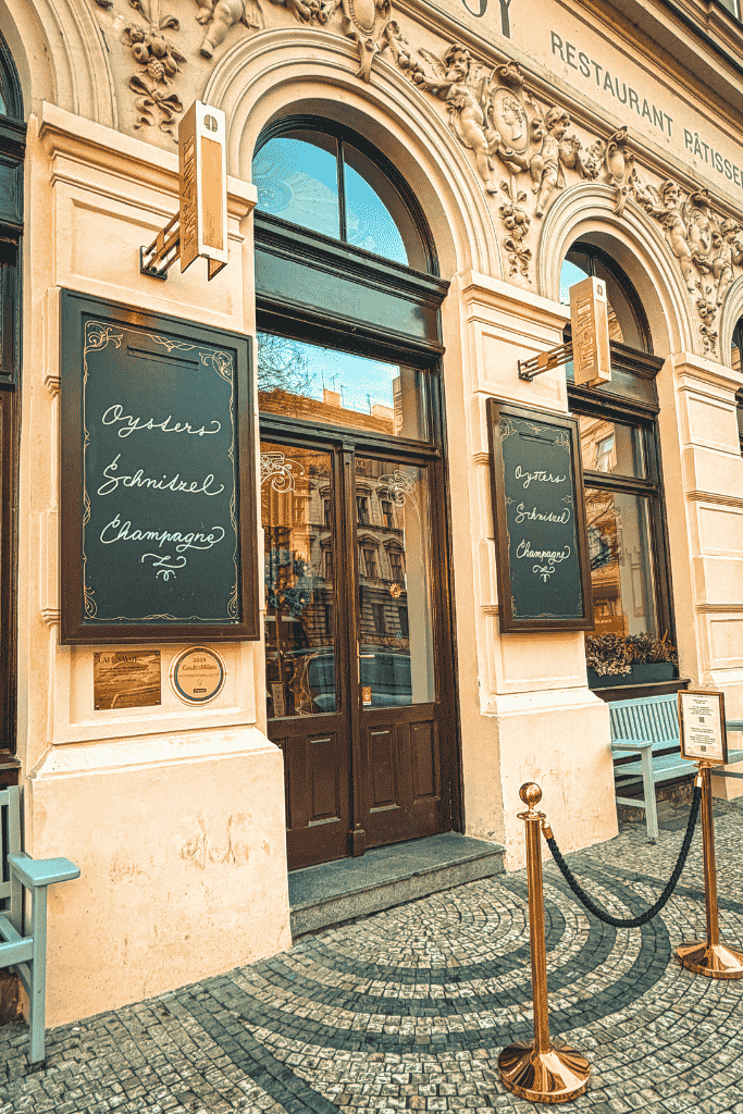 The elegant façade of Café Savoy in Prague, a historic café known for its grand interiors, classic pastries, and leisurely breakfasts.
