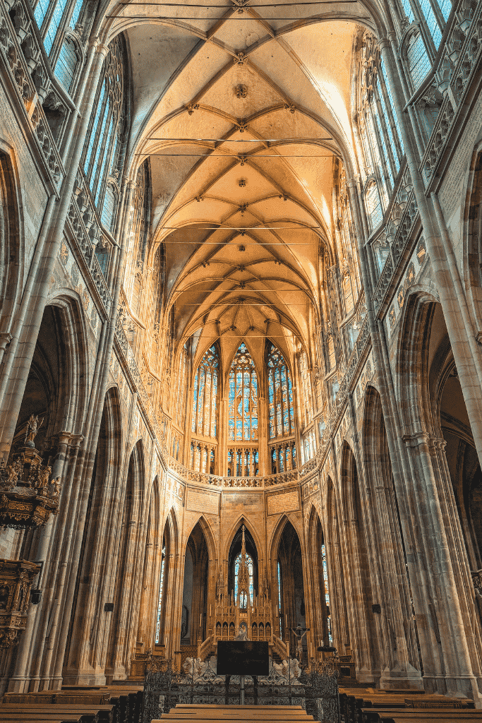 Inside St. Vitus Cathedral, where soaring Gothic arches and colorful stained-glass windows make the vast interior just as impressive as its dramatic exterior.