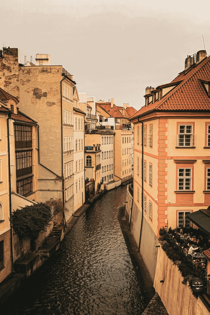 A quiet winter view over Prague’s Čertovka canal, where pastel historic buildings and red-tiled rooftops create one of the most picturesque corners of the city’s Lesser Town.