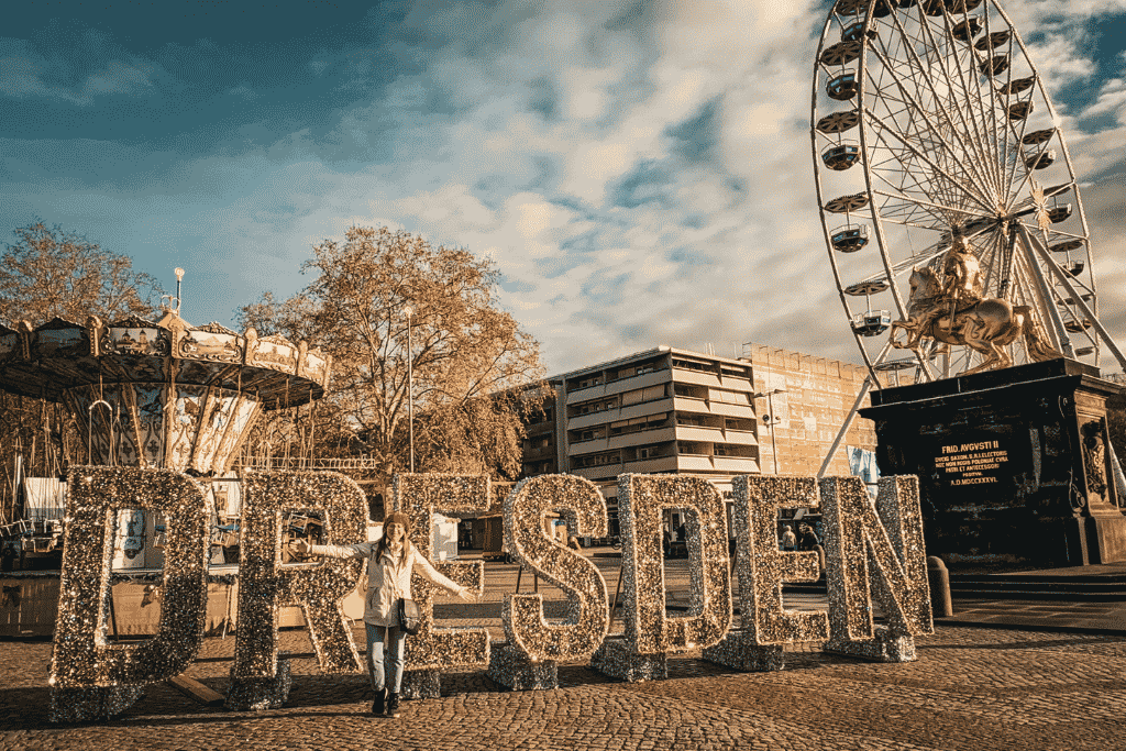 Festive Dresden welcomes visitors with a sparkling city sign, Ferris wheel, and the Golden Rider—a cheerful introduction to the city during Christmas market season.
