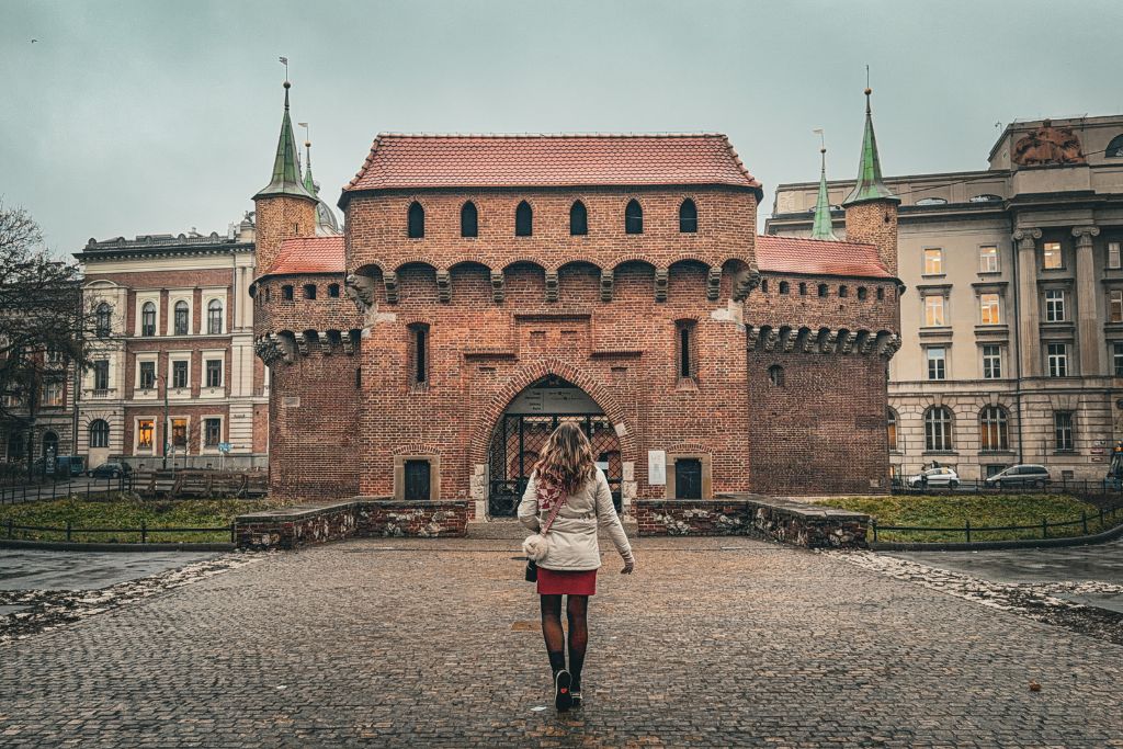 Kate walking toward Krakow’s historic Barbican while exploring the Old Town.