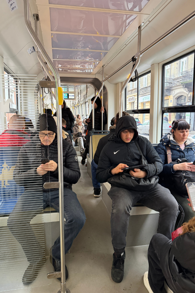 Passengers riding inside a modern tram in Krakow, Poland.