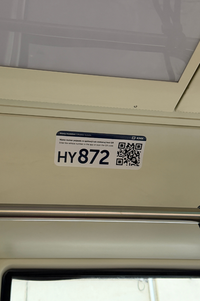 QR code and vehicle number inside a Krakow tram used to purchase mobile transit tickets.