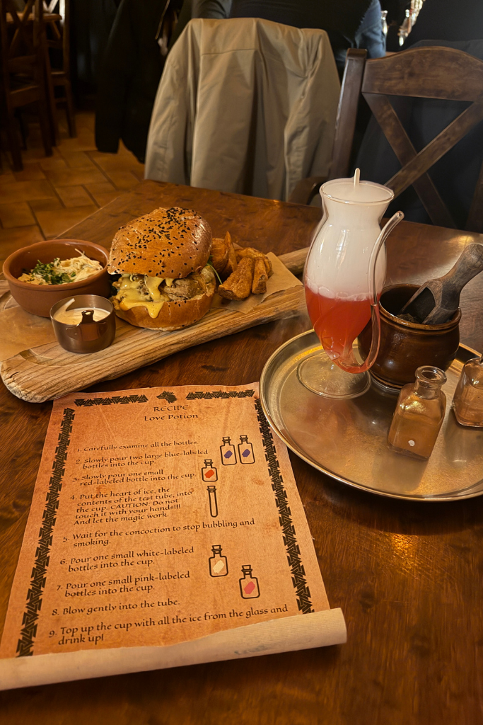 Love Potion cocktail experience with a burger and fries at Tawerna Wilczy Dół in Krakow.