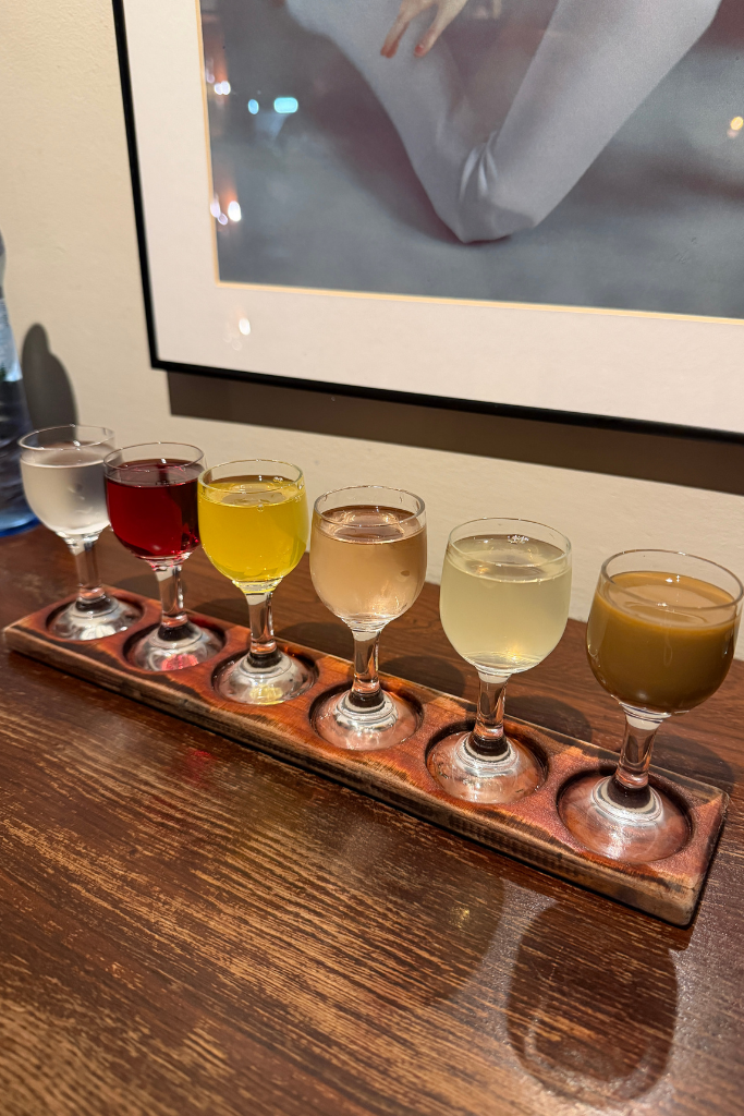 Flight of six colorful flavored Polish vodkas at Wódka Café Bar in Krakow.