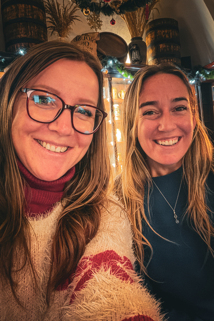 Kate with another solo traveler enjoying a night out at Wódka Café Bar in Krakow.