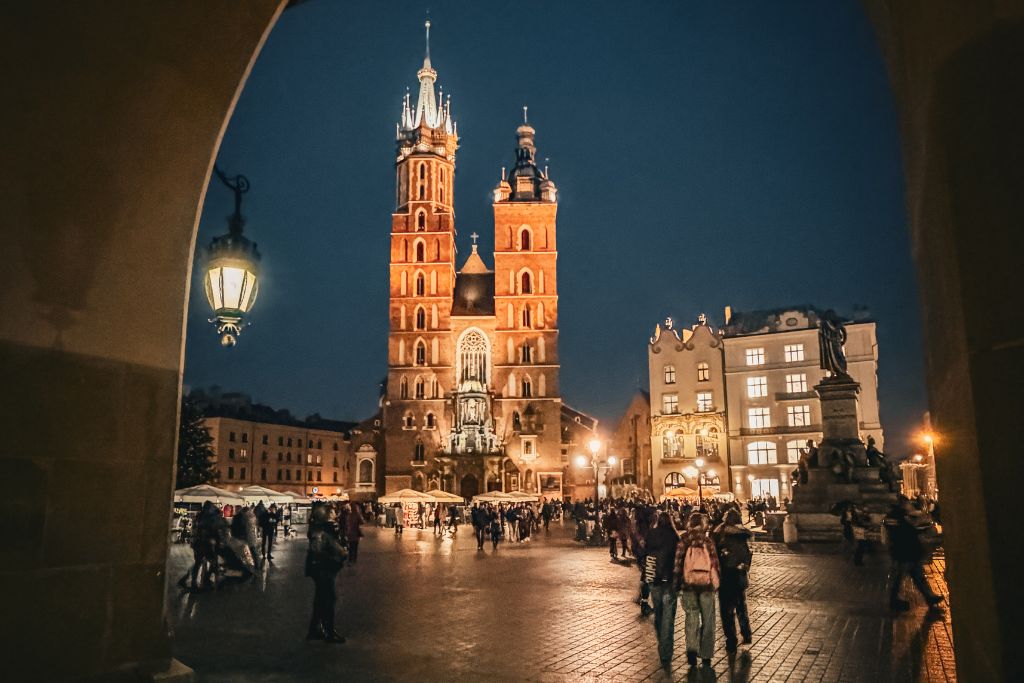 St. Mary’s Basilica illuminated at night in Krakow’s Main Market Square.